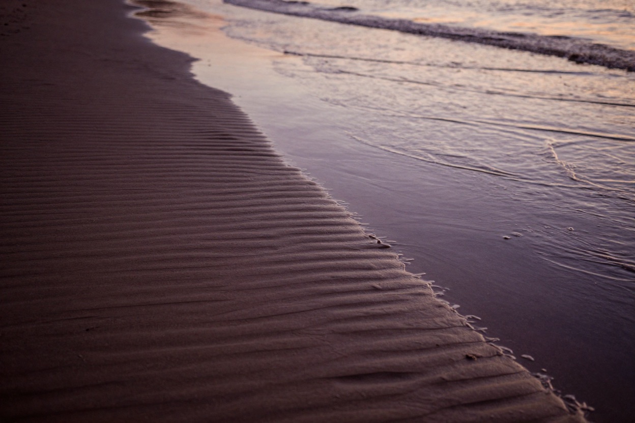The tide coming in over rippled sand
